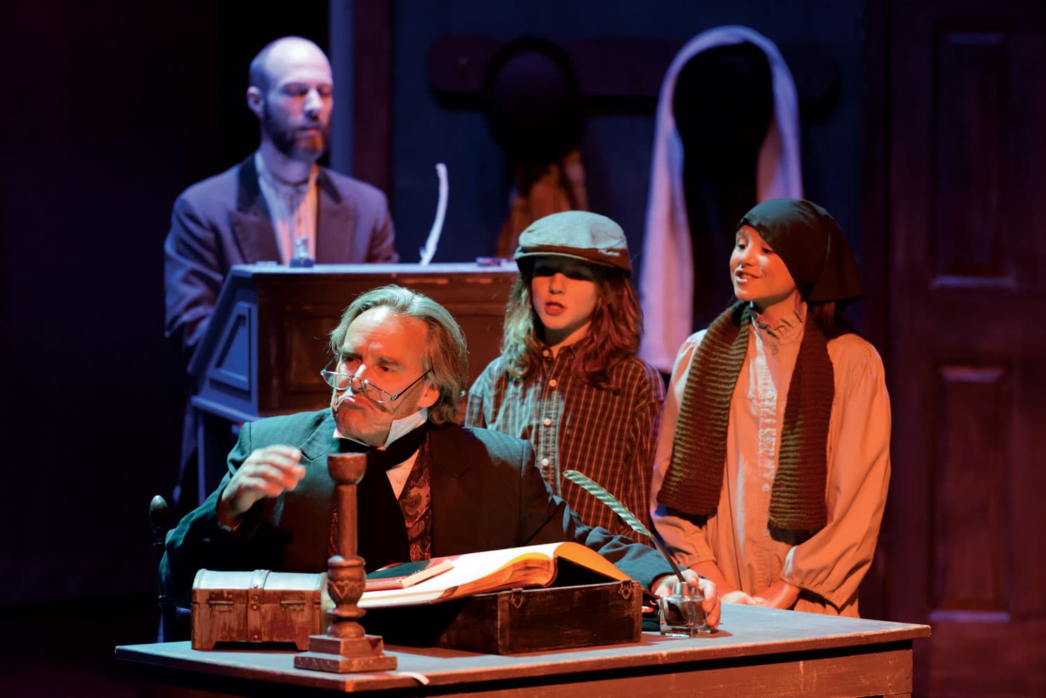 Actors and actresses perform a Christmas play on stage