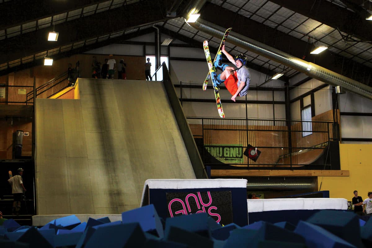 A person in a helmet does a trick in the air at Woodward Copper at Copper Mountain