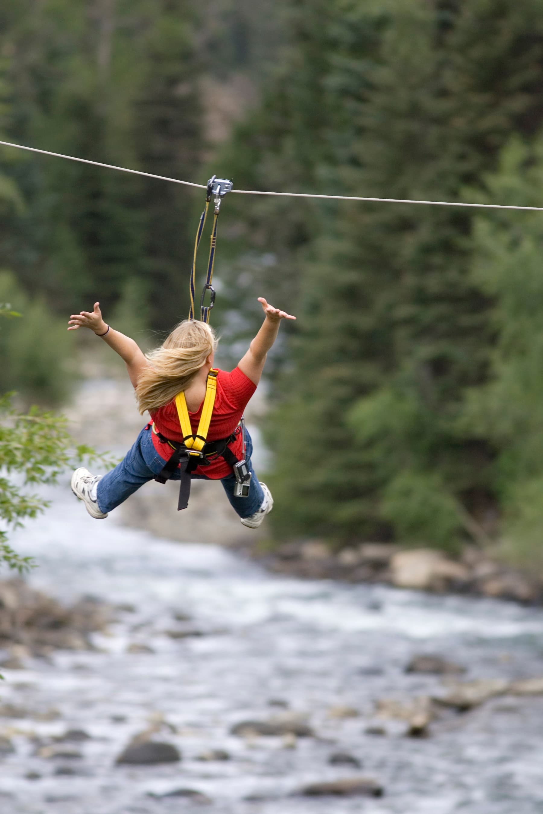woman soaring over river at durango zip line in colorado photo 8