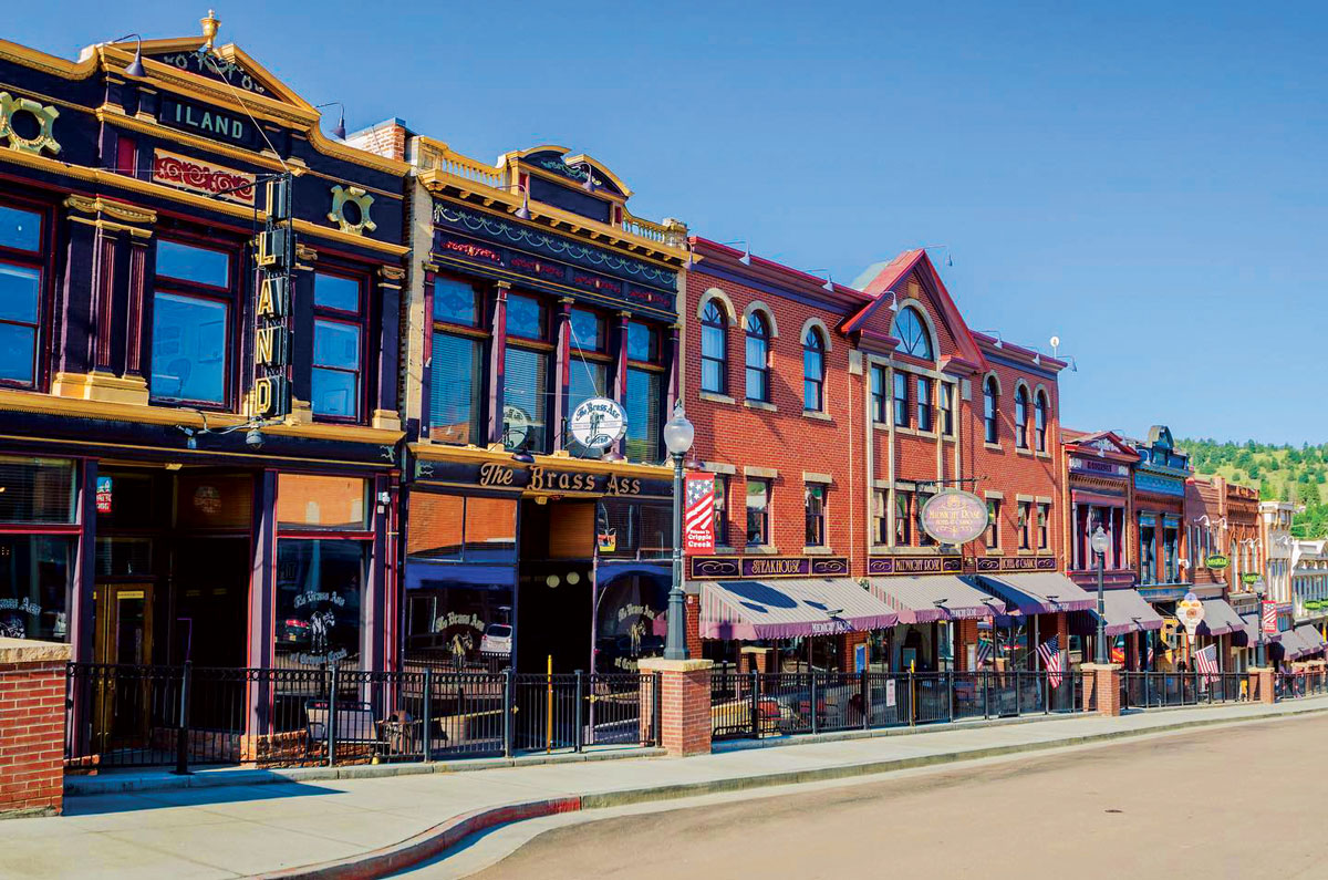 Wooden exterior of Midnight Rose Casino & Hotel in Cripple Creek on a blue-sky day
