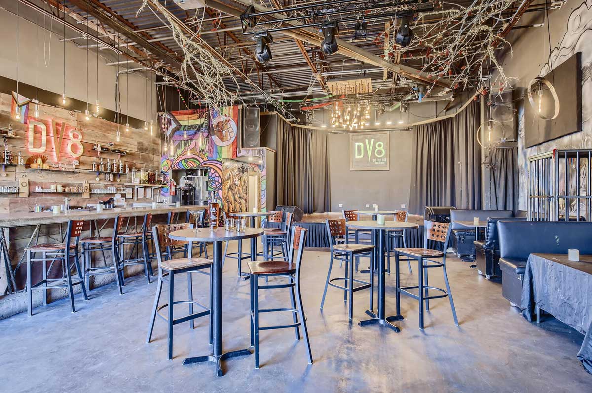 DV8 Distilling's tasting room in Boulder features a bar, tables, a stage and more