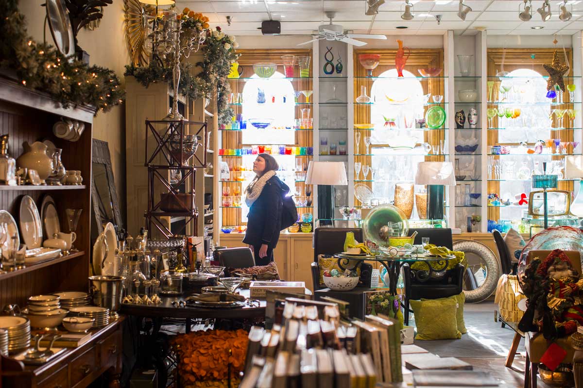 A person stands amid shelves and aisles of kitchen decor