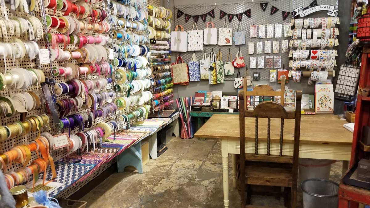 A crafting room packed with ribbons, stickers, wrapping paper and more