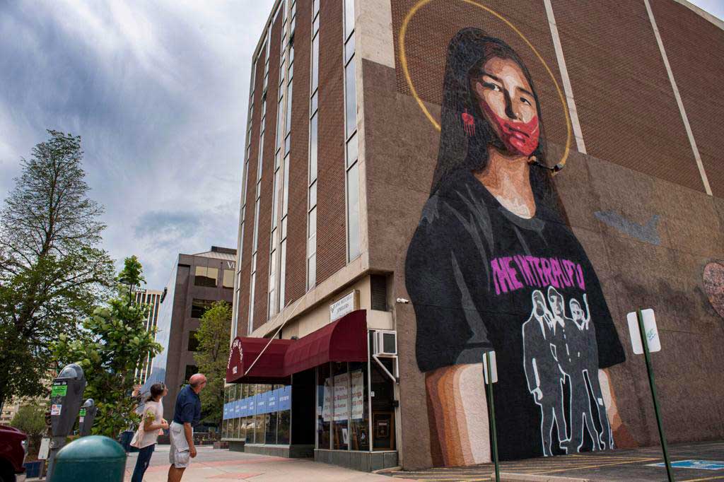 A mural of a person on the side of a building