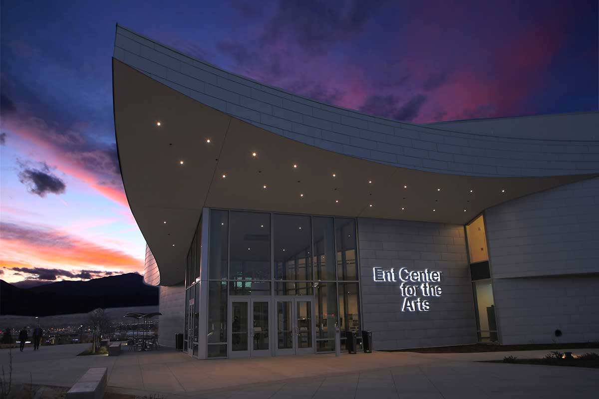 an arts building with architectural angles lit up by the setting sun
