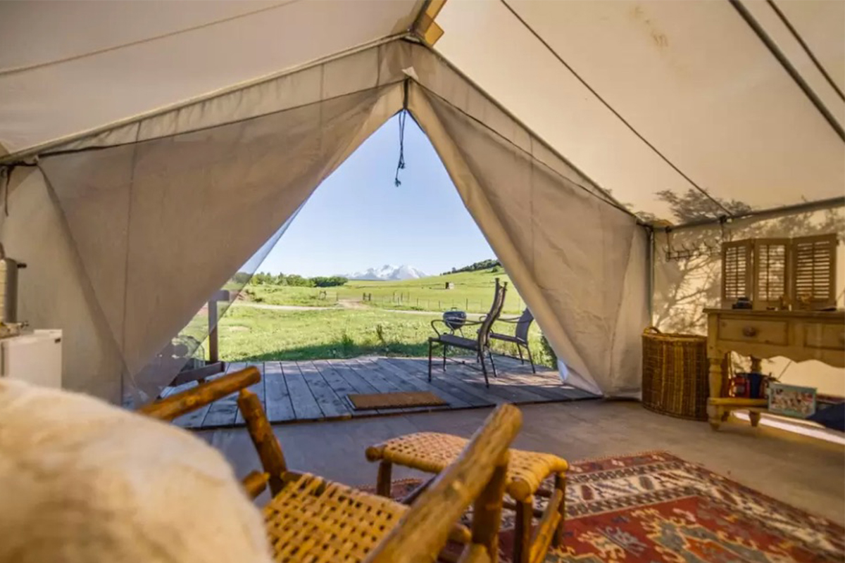 From inside a white-canvas tent at Cedar Ridge Ranch in Carbondale, Colorado, you can see snow-capped peaks in the distance.