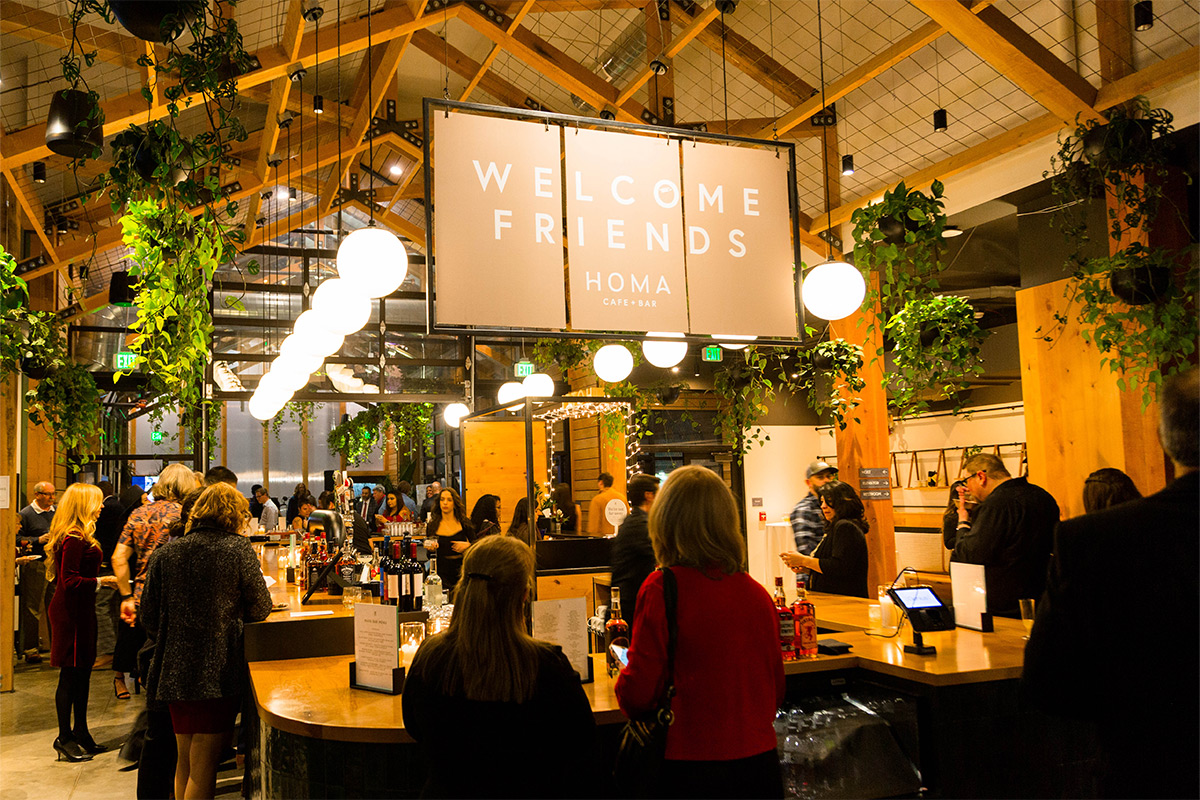 People mix and mingle at an event at the Homa Cafe + Bar in Kinship Landing.