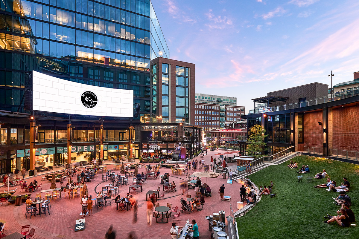 People gather in McGregor Square outside The Rally Hotel in Denver to watch an evening movie in summer.