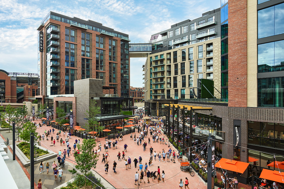 People explore the plaza and outdoor dining areas near The Rally Hotel in Denver, Colorado.