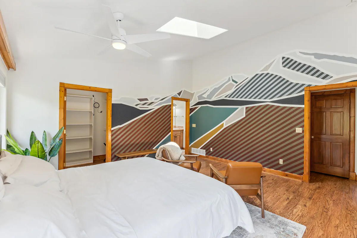 A striped mountains reach towards the ceiling of the minimalistic bedroom at Hot Tub Area of Hummingbird Hill in Colorado.