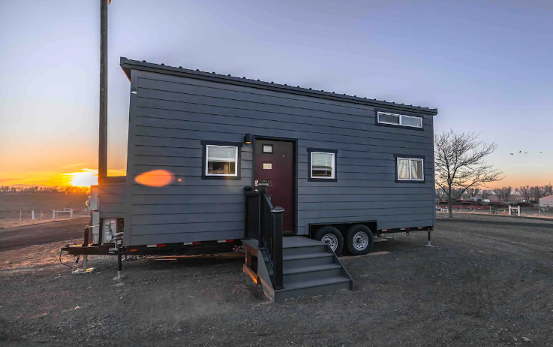 A blue-gray tiny house on a Hudson horse farm
