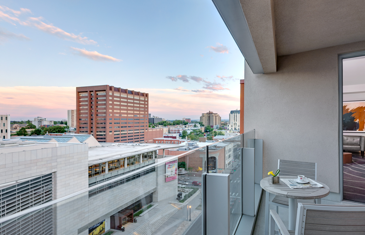 Views of downtown Denver at sunset from The Art; clouds in the faintly blue sky are shades of pink