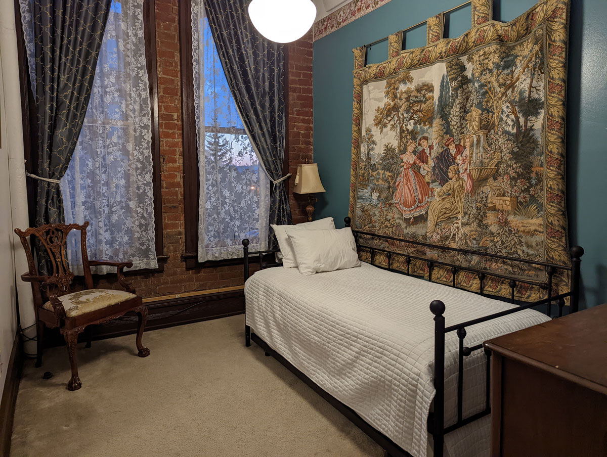 Hotel-room interior at Delaware Hotel in Leadville, with teal-green walls and Victorian furnishings