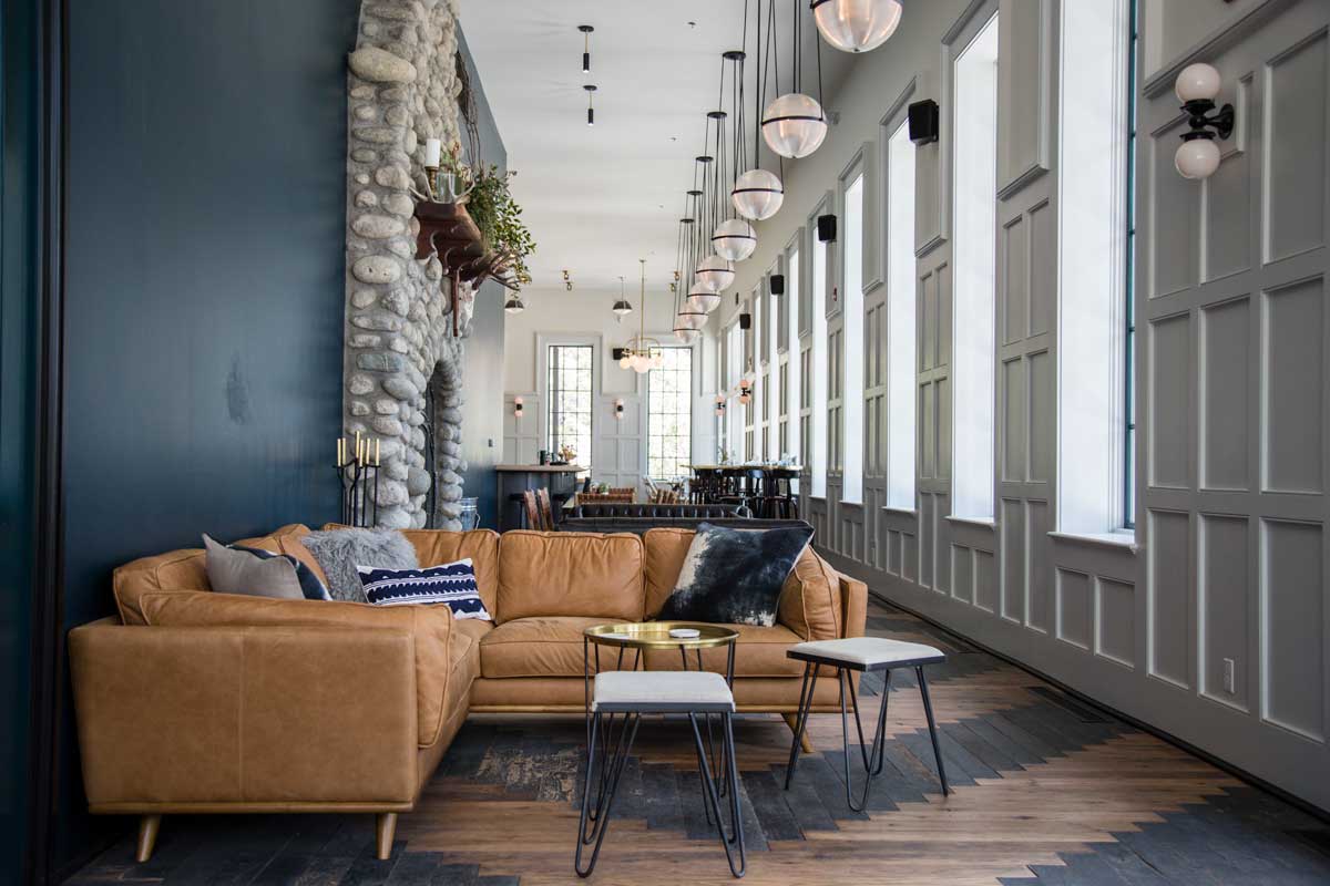 The Wesley & Rose lobby bar is a located on site at the Surf Hotel. The lobby bar features a stone fireplace and tan leather couches.