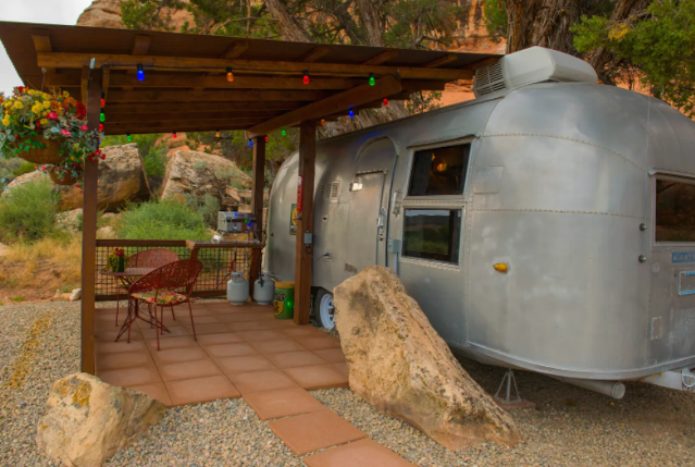Canyon Hideout Bungalow Airstream seen next to a dark-wood pergola