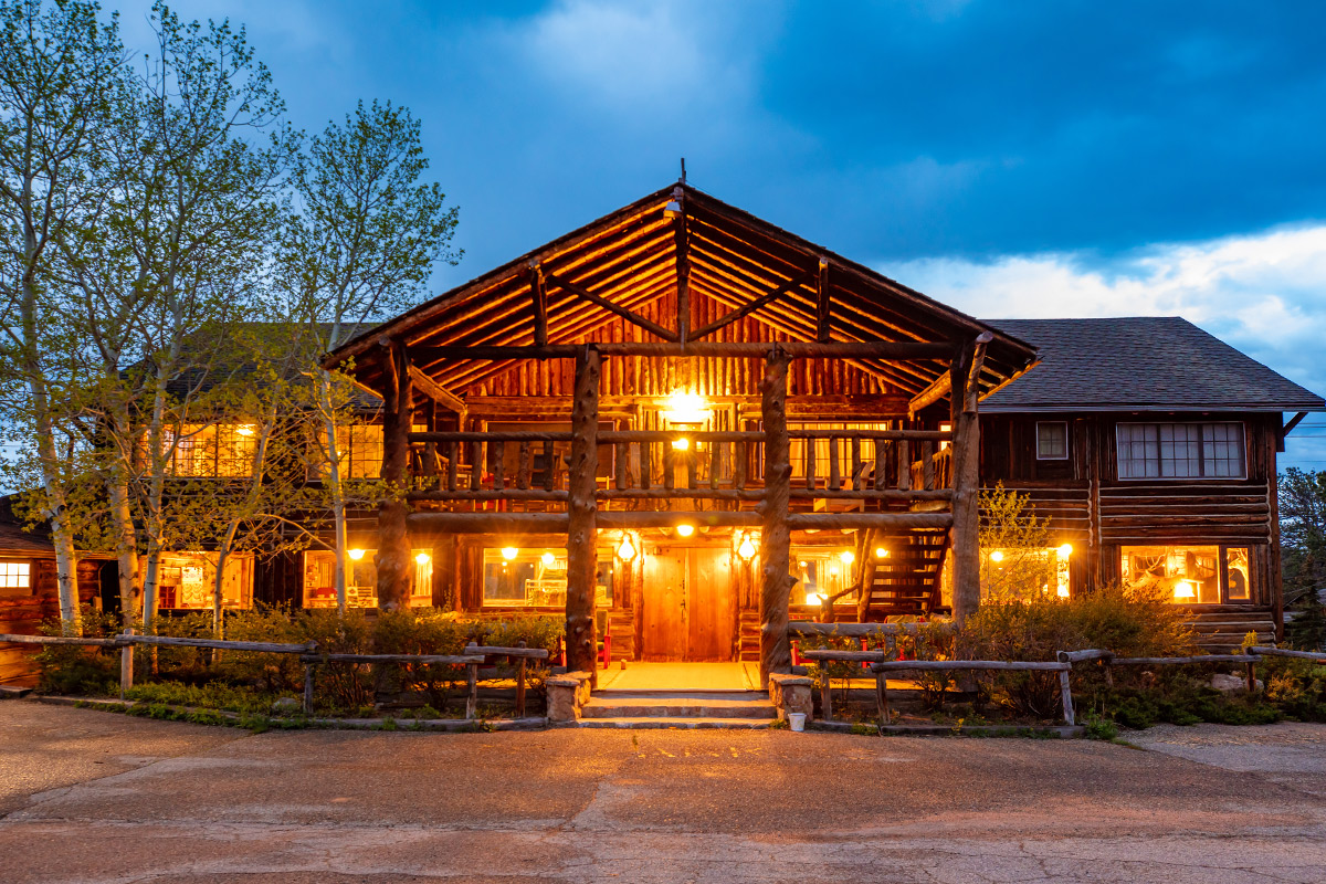 As dusk falls, the Meeker Park Lodge is set aglow with warm lights the beckon weary adventurers near Allenspark, Colorado.