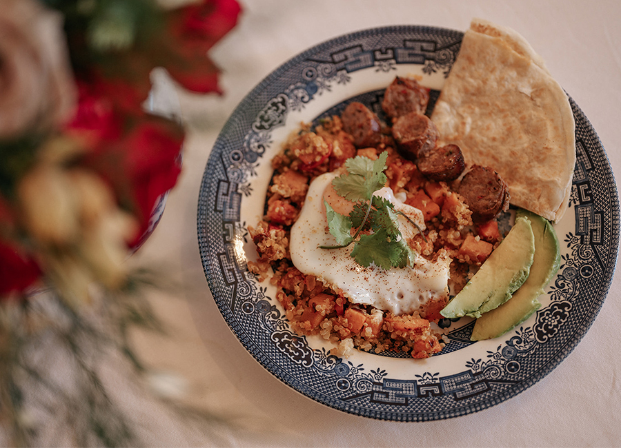 An intricately decorated bowl holds a filling breakfast of sausage, quinoa, egg, avocado and pita, at the Gable House Bed & Breakfast.