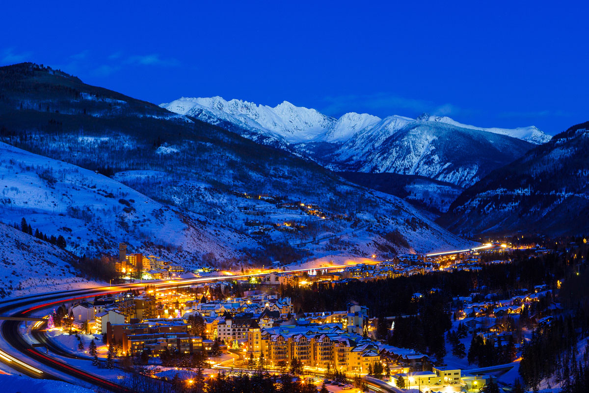 Vail Colorado at night with town lights illuminating against the night sky