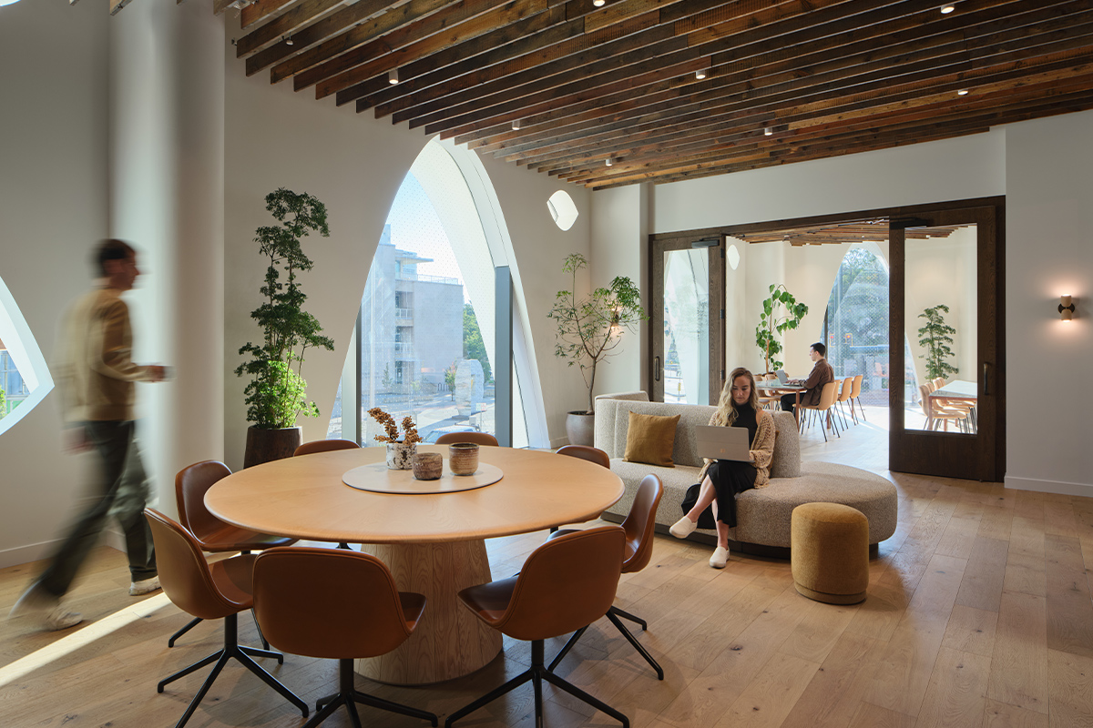 Inside Denver's Populus hotel, digital nomads sit at their computers in spacious work areas completing tasks.