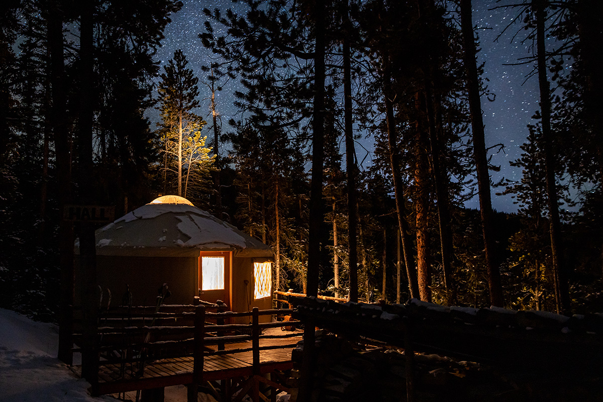 A clear night sky bursts with twinkling stars above the ground of the Tennessee Pass Sleep Yurts near Leadville, Colorado.