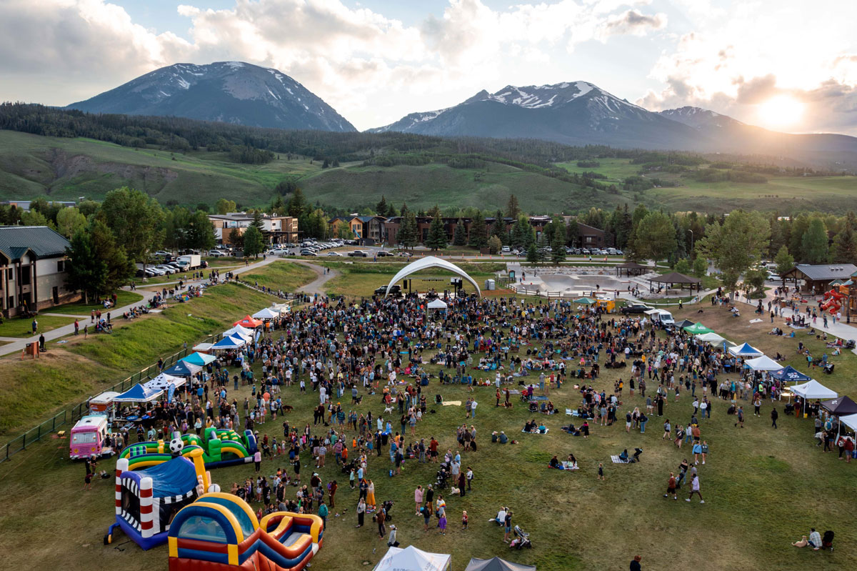Outdoor music event with a mountain backdrop in SIlverthorne Colorado
