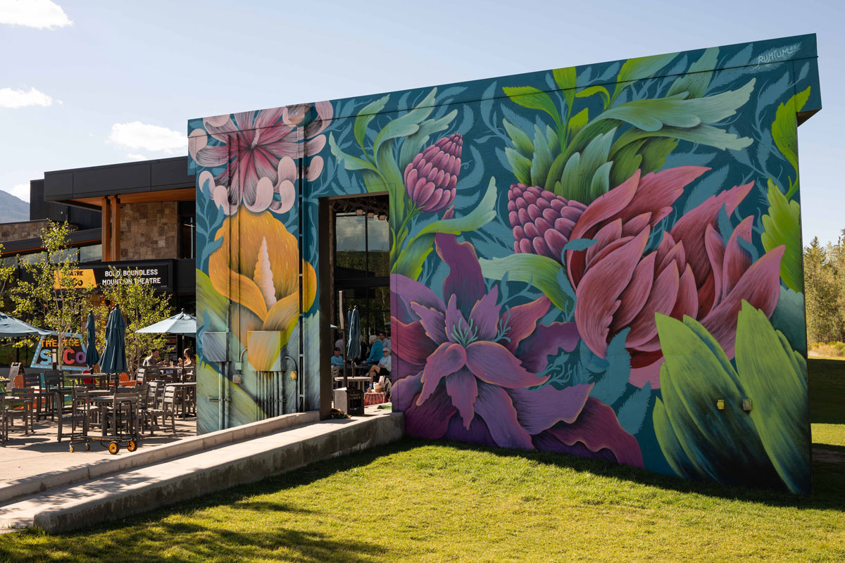 vibrant purple, pink and yellow flowers painted on the side of a building