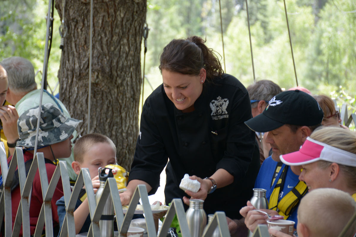 A chef checks in on a family enjoying lunch outdoors near the Animas River in Colorado.