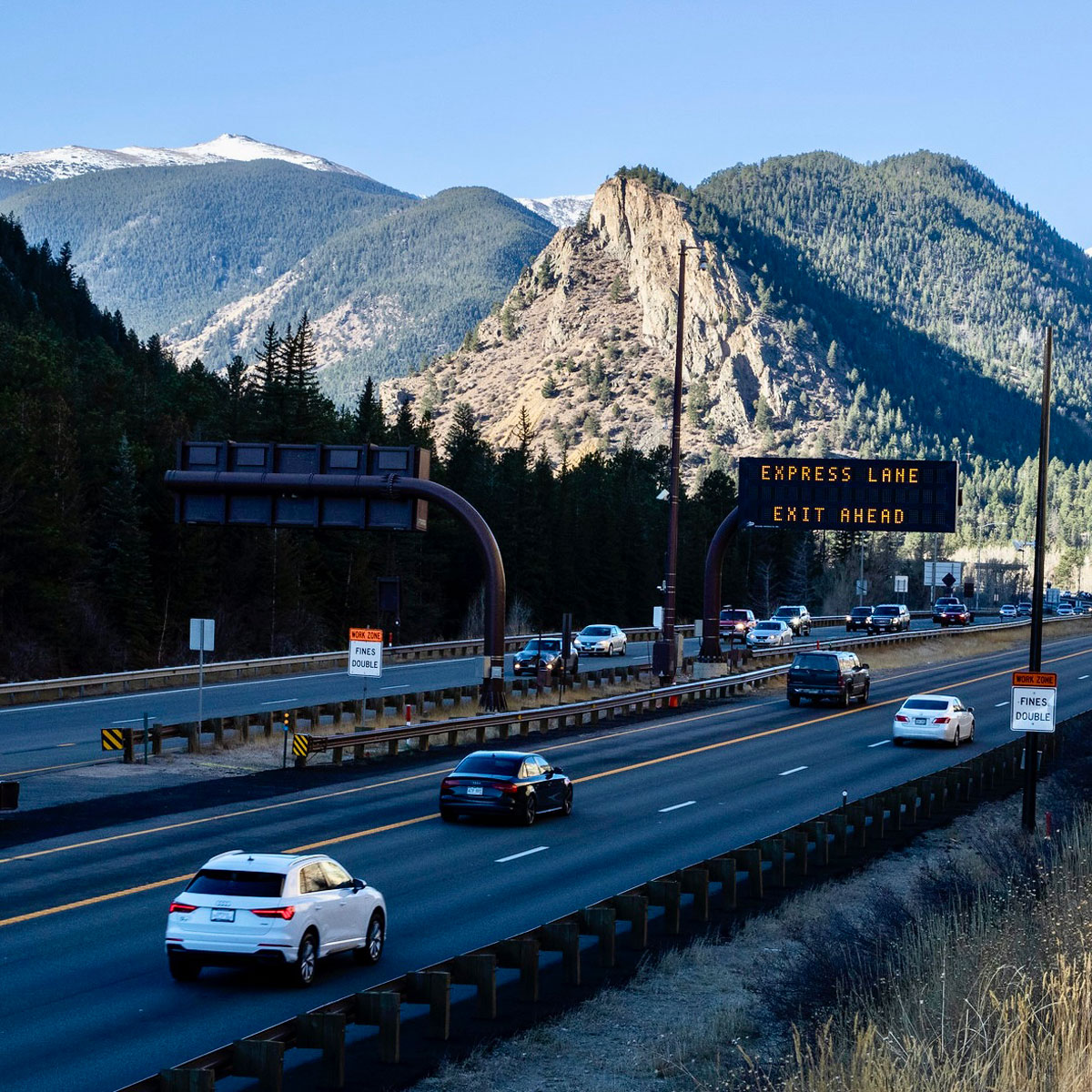 Mountain Express Lanes with a backdrop of towering mountains in Colorado.