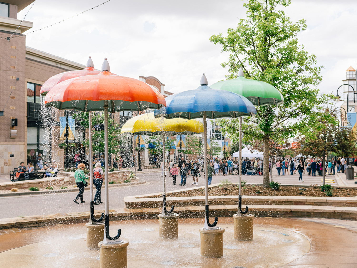 A splash pad in Aurora, Colorado, at which the water showers from features that look like umbrellas. 