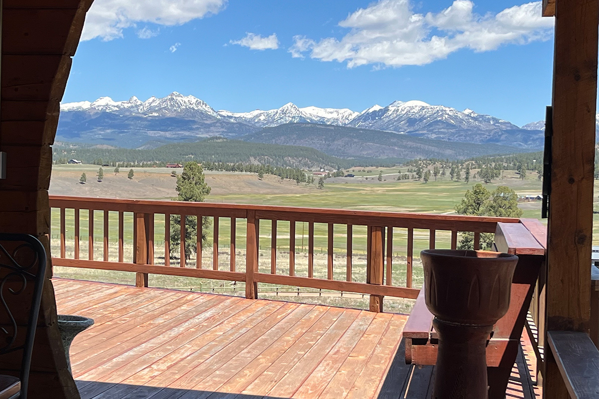 From the wooden deck of the Elkwood Manor Bed & Breakfast, you can see uninterrupted views of the snowcapped San Juan Mountains in Colorado.