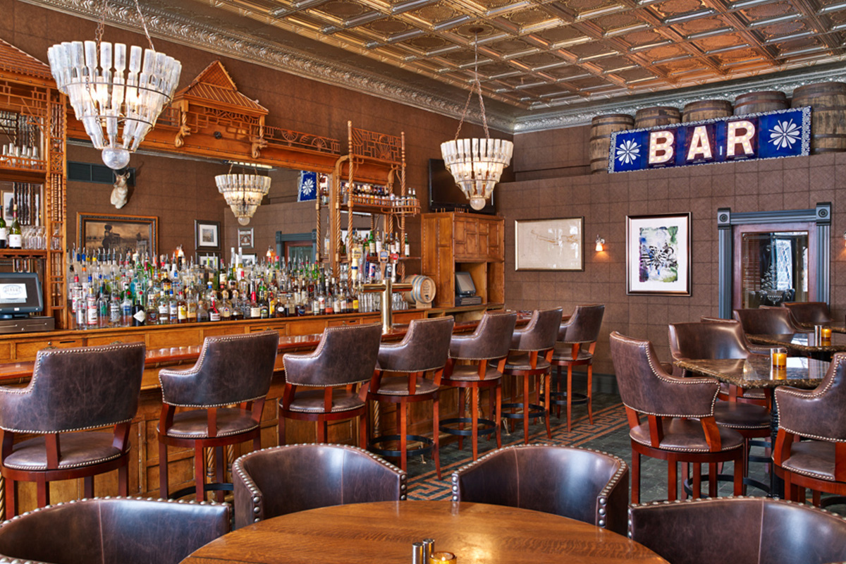 In Aspen, Colorado, Hotel Jerome's J-Bar is decorated with empty-bottle chandeliers, an intricately carved bar and studded leather chairs.