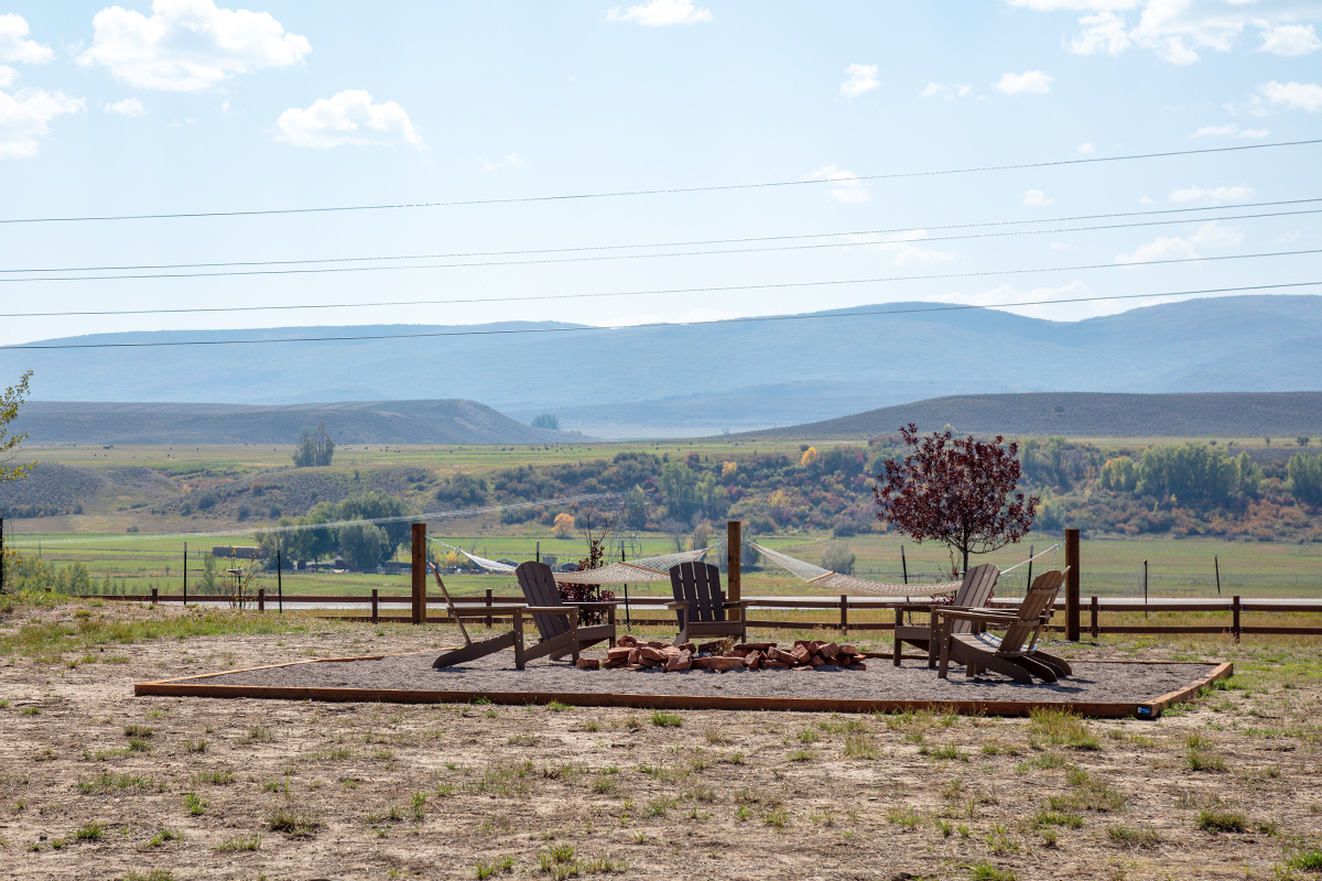 A communal space at Trail and Hitch near Meeker, Colorado, offers Adirondack chairs and hammocks from which to enjoy the surrounding vistas.