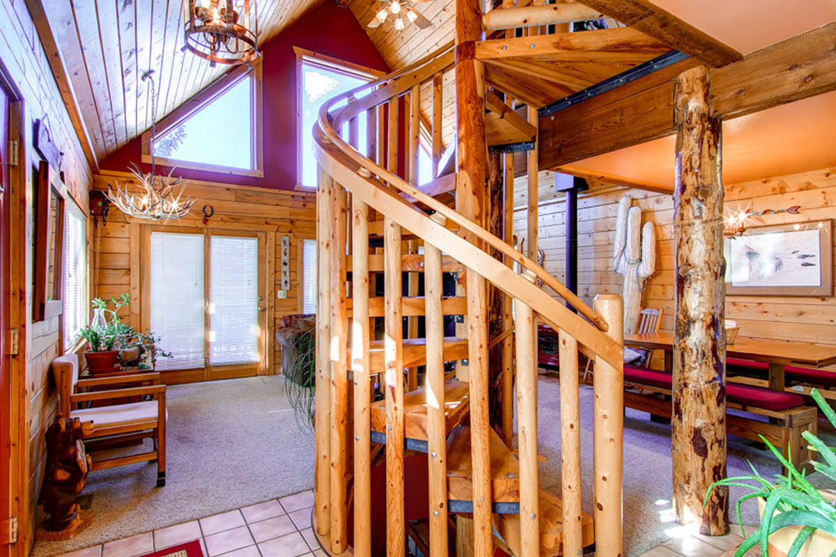 A knotty, wooden spiral staircase sits in the heart of this rental in Dillon, Colorado.