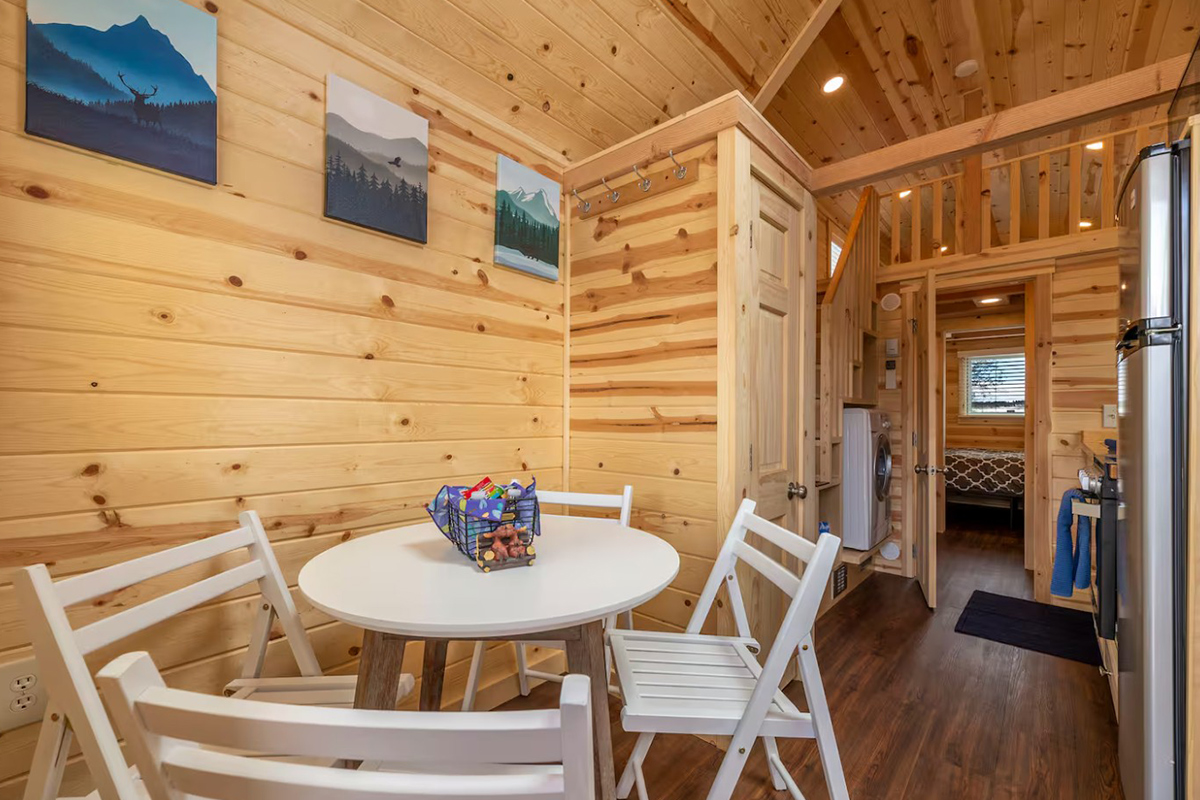 Four white chairs stand around a white table in the breakfast nook of the Tumbleweed in Fairplay, Colorado.
