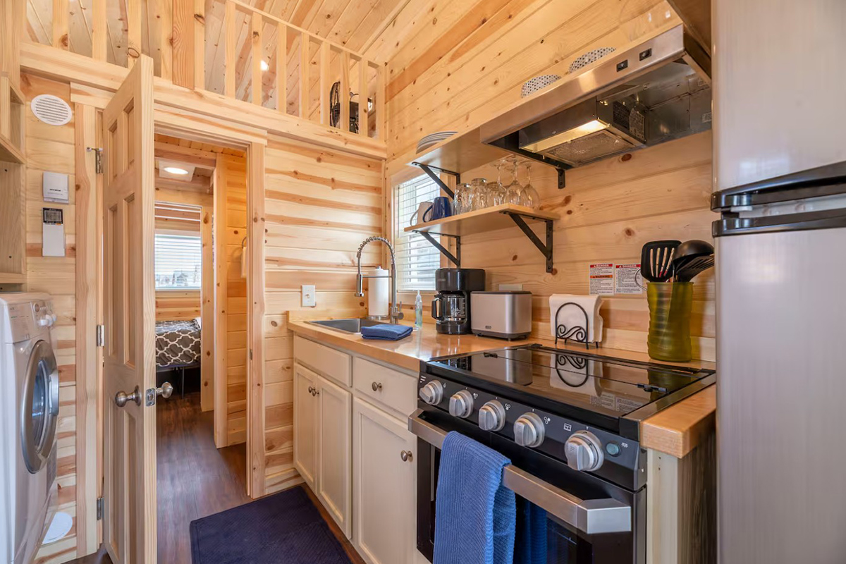 The Tumbleweed's kitchen is well-equipped with an oven, stove, full sink and cooking utensils.