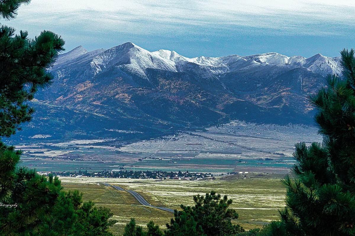 Snow-capped mountains rising over the small town of Silver Cliff in Colorado.
