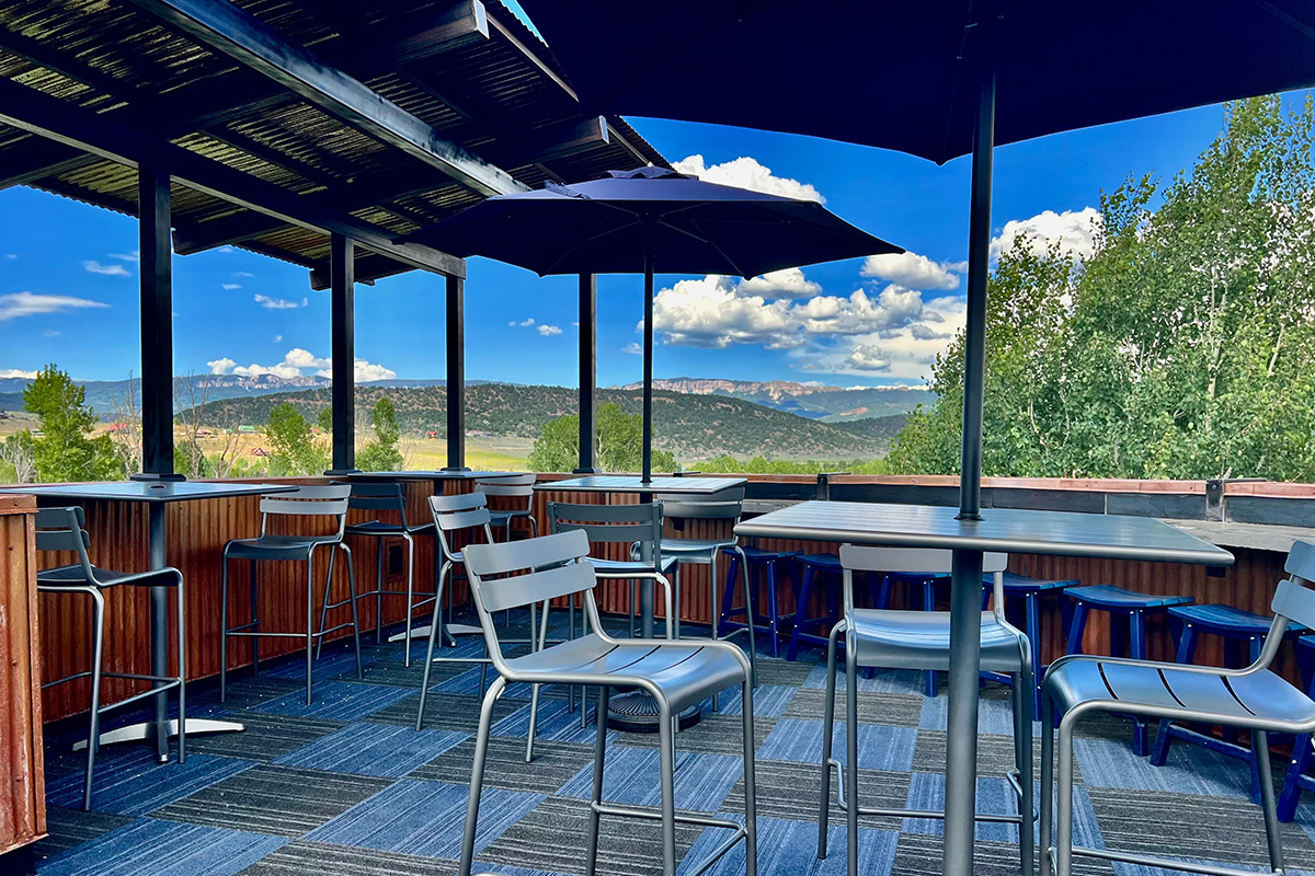 The rooftop terrace at the White Buffalo Restaurant + Bar in the Ridgway, Colorado, offer stunning views of the surrounding mountains.