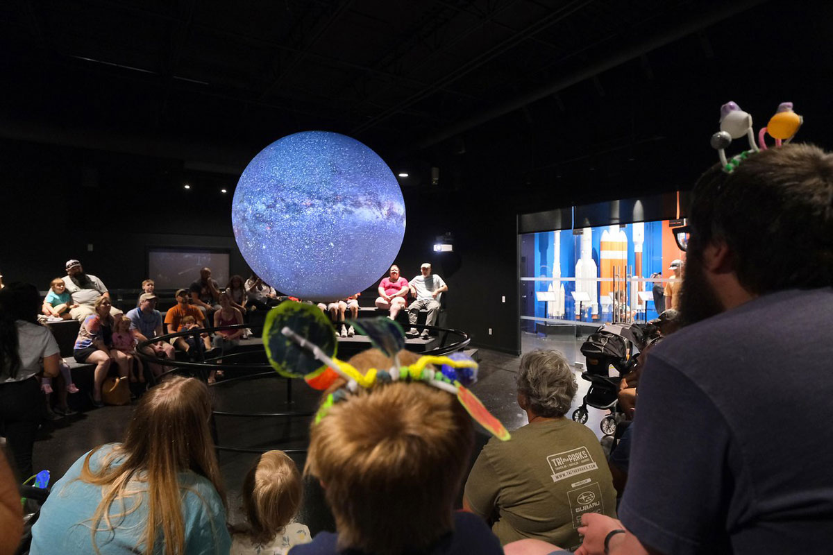 Visitors watch a suspended galaxy display at the Space Foundation Discovery Center in Colorado Springs