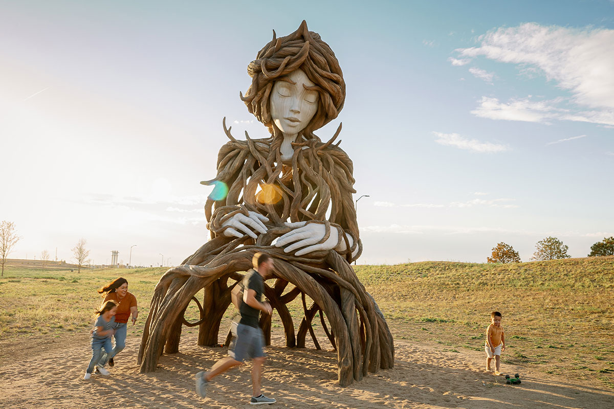 Children play around the “Umi” sculpture at Hogan Park in Aurora, Colorado