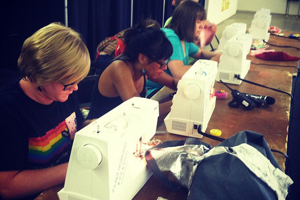 contestants intently work at sewing machines at Denver County Fair's live sewing challenge
