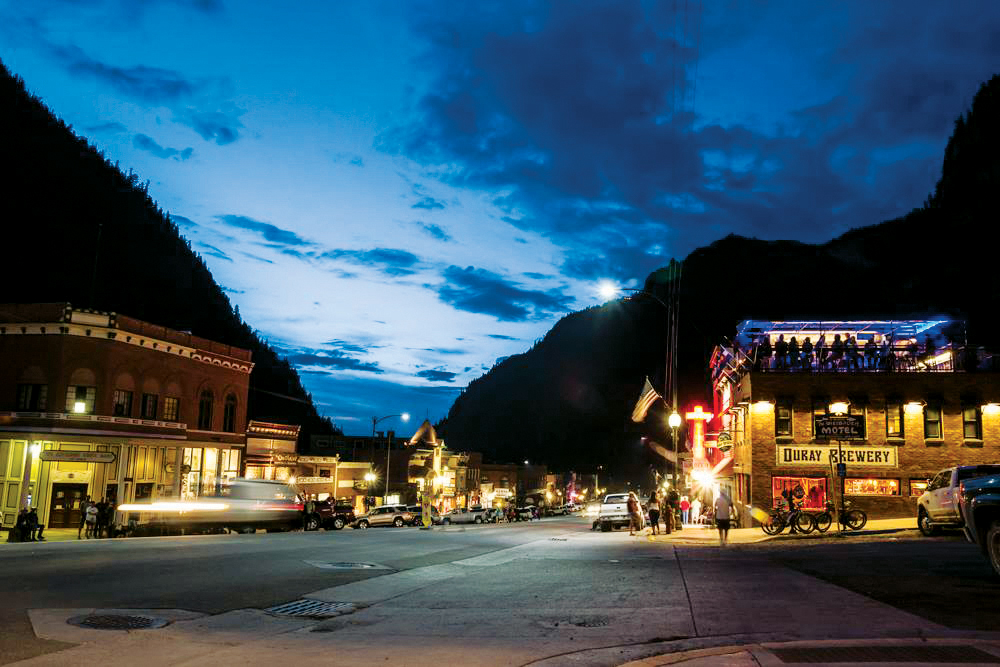 Lights glow on summer evening at Ouray Brewery on Ouray's Main Street