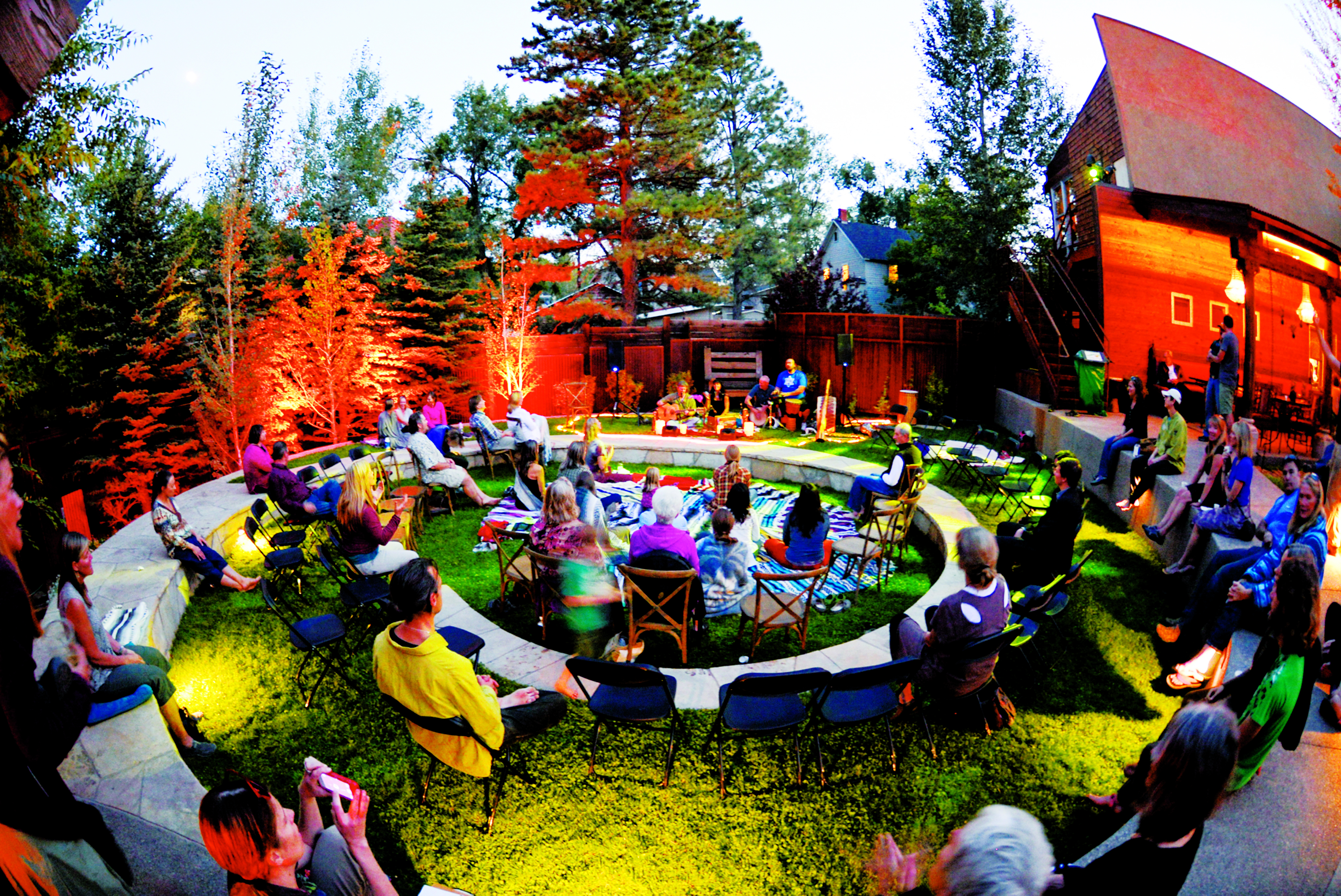 People sit on camping chairs and watch a music performance in the Carbondale Creative District