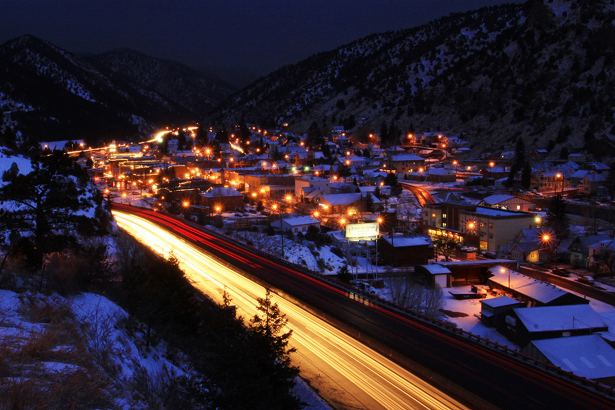 The town of Idaho Springs glows with light on a dark evening