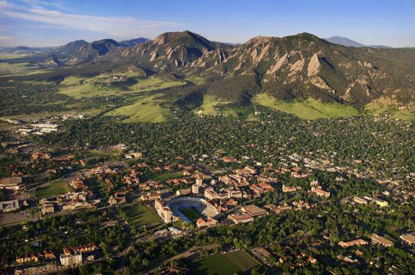 An aerial view of the CU campus in Boulder where the buildings meet the Flatiron mountains.