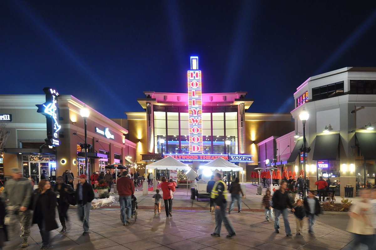 The Hollywood movie theater in The Streets at SouthGlenn sits in the middle of lots of people walking around the mall at night.