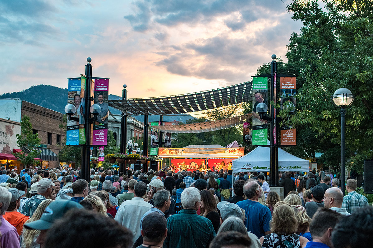 The sun sets over a stage performance at Band on the Bricks in Boulder