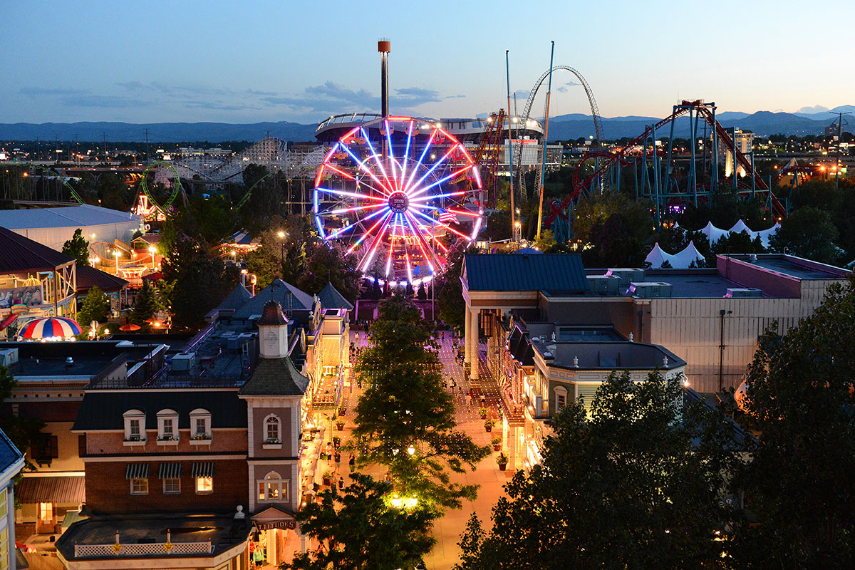 The Ferris wheel glows with bright colored lights at Elitch Gardens in Denver at night