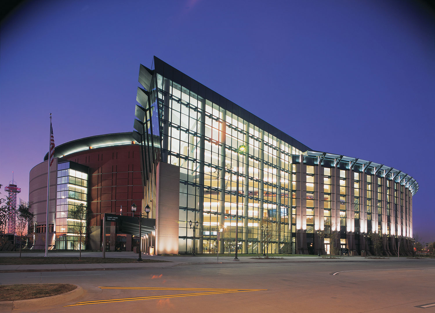 Exterior view of a large performance venue lit up at night against a dark sky