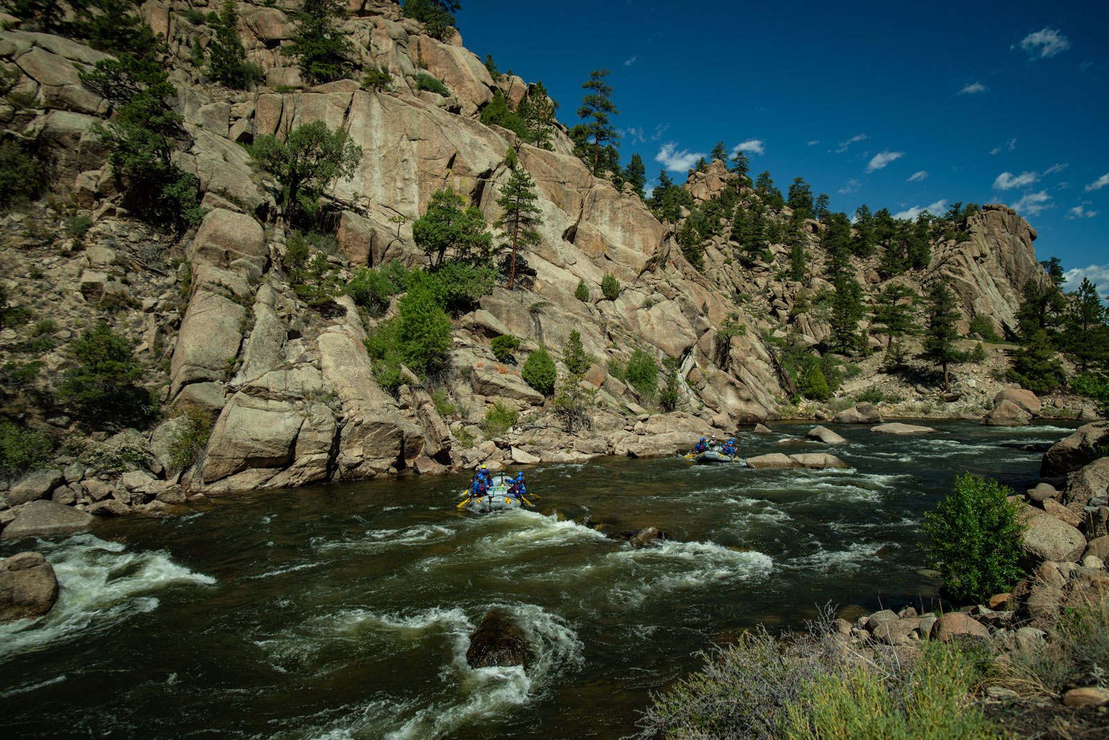 Whitecapped rapids rush between canyon walls