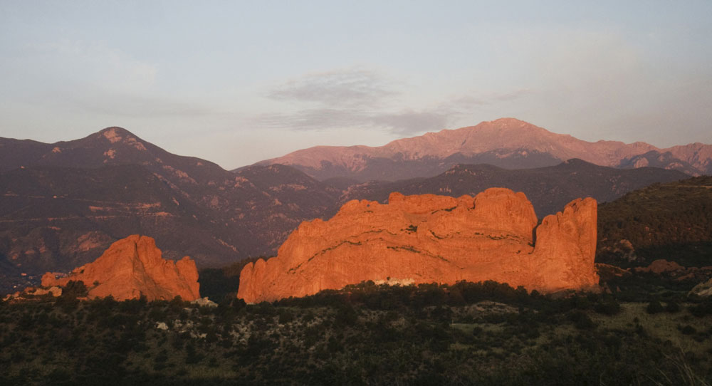 Red rocks with mountains in the background at Garden of the Gods in Colorado Springs